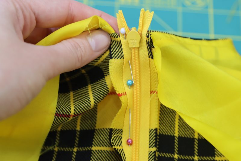 How To Pin Opposite Side Zipper - Invisible Zipper - Mood Fabrics - Silverstone Mini Dress Free Sewing Pattern Tutorial - MDF489 - Mood Fabrics Sewciety Blog - Pin the other side of the zipper to the opposite side of the center back of the dress.