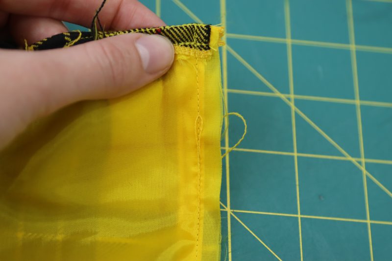 How To Sew Lining To Center Back Seam - Bemberg Lining - Mood Fabrics - Silverstone Mini Dress Free Sewing Pattern Tutorial - MDF489 - Mood Fabrics Sewciety Blog - Sew a straight stitch along one side of the center back, catching the zipper and both fabric.