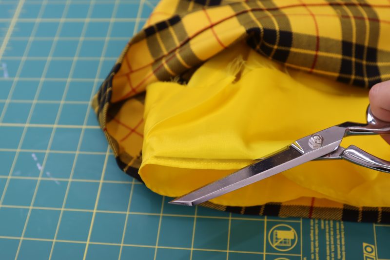 How To Trim Lining Raw Edge - Bemberg Lining - Mood Fabrics - Silverstone Mini Dress Free Sewing Pattern Tutorial - MDF489 - Mood Fabrics Sewciety Blog - Trim the seam allowance as close to the hem as possible.
