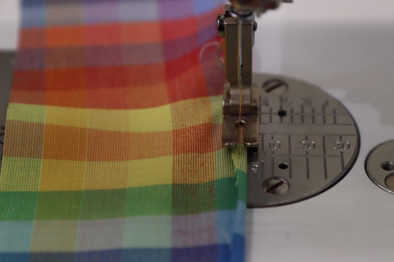 How To Sew Baby Hem On Ruffles - Rainbow Checks Cotton Shirting - Mood Fabrics - Bayport Blouse Free Sewing Pattern Tutorial - MDF494 - Mood Fabrics Sewciety Blog - Sew a ⅛ inch hem along the raw edges of each of the ruffle pieces.