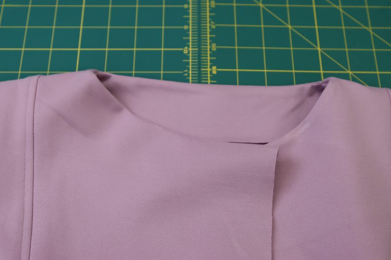 How To Press Neckline Facing - Stretch Ponte Knit - Mood Fabrics - Camarillo Cardigan and Magdalene Midi Skirt Free Sewing Pattern Tutorial - MDF490 - Mood Fabrics Sewciety Blog - Press the neckline facing towards the inside of the cardigan.
