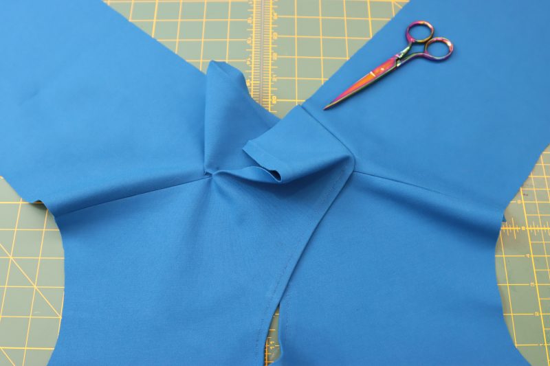 How To Sew Top Collar To Right Back Neckline - Stretch Ponte Knit - Mood Fabrics - Topeka Keyhole Dress Free Sewing Pattern Tutorial - MDF496 - Mood Fabrics Sewciety Blog - Sew the top front collar piece to the back right neckline.