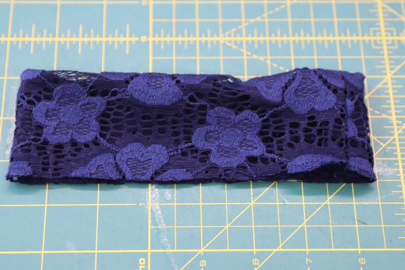 How To Fold Collar Wrong Sides Together - Stretch Crochet Lace - Mood Fabrics - Altena Blouse Free Sewing Pattern Tutorial - MDF491 - Mood Fabrics Sewciety Blog - Fold the collar wrong sides together to hide the seam allowance inside of the collar.