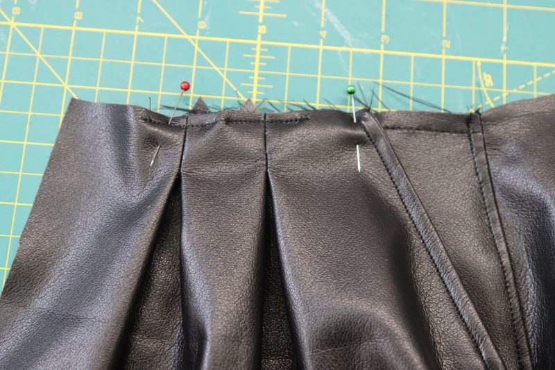How To Pin Pocket To Waistline - Buttery Faux Leather - Mood Fabrics - Dresden Shorts Free Sewing Pattern Tutorial - MDF493 - Mood Fabrics Sewciety Blog - Pin the top of the pocket bag to the front waistline of the shorts.