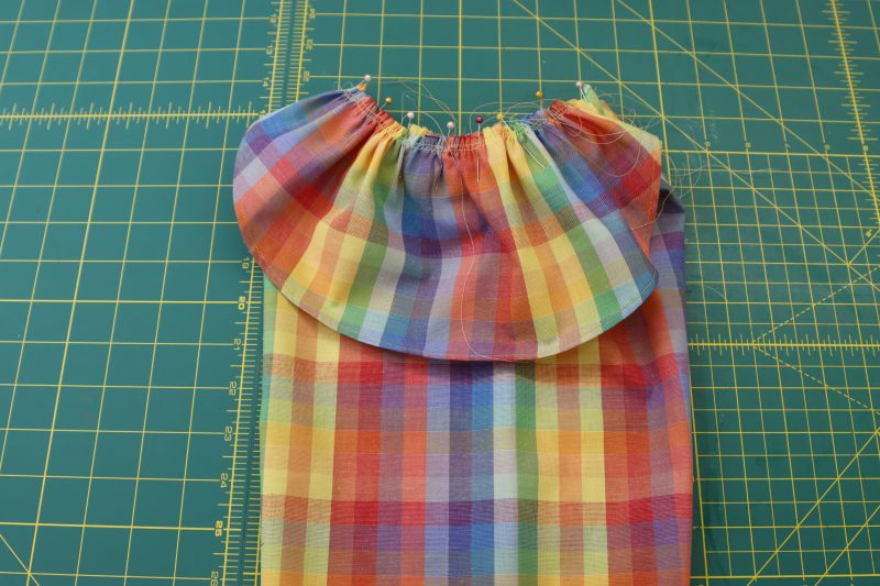 How To Pin Shoulder Ruffle To Sleeve Cap - Rainbow Checks Cotton Shirting - Mood Fabrics - Bayport Blouse Free Sewing Pattern Tutorial - MDF494 - Mood Fabrics Sewciety Blog - Pin the shoulder ruffle centered on the gathered sleeve cap.