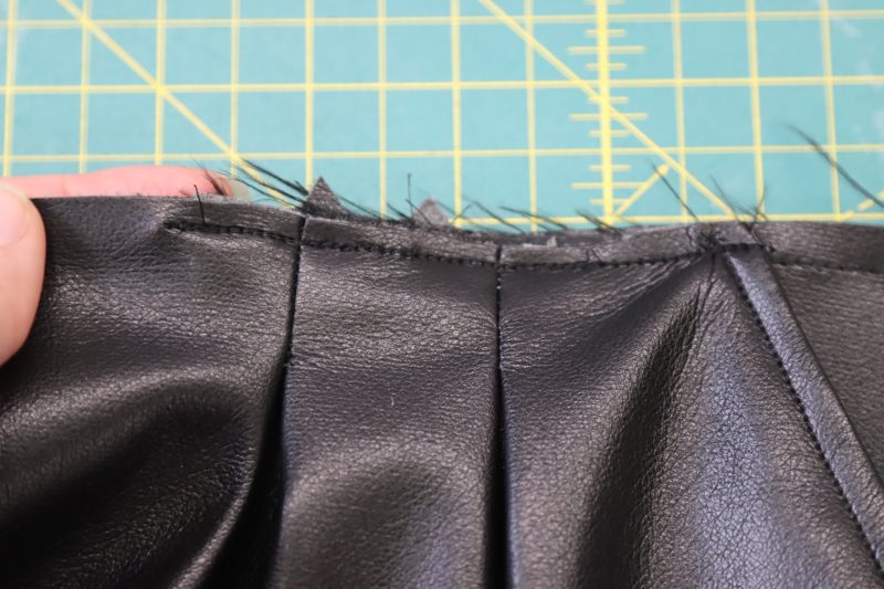 How To Sew Pocket To Waistline - Buttery Faux Leather - Mood Fabrics - Dresden Shorts Free Sewing Pattern Tutorial - MDF493 - Mood Fabrics Sewciety Blog - Sew the top of the pocket bag to the shorts with ¼ inch seam allowance.