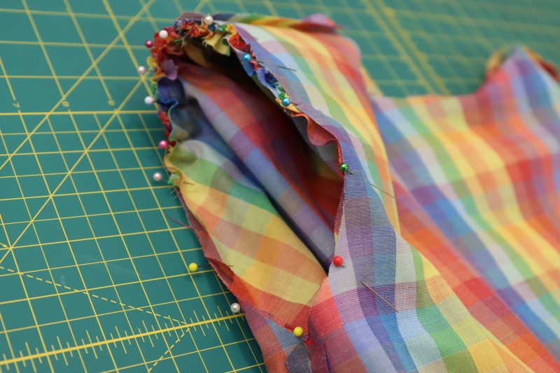 How To Pin Sleeve Caps To Armscyes - Rainbow Checks Cotton Shirting - Mood Fabrics - Bayport Blouse Free Sewing Pattern Tutorial - MDF494 - Mood Fabrics Sewciety Blog - Pin the sleeve cap to the armscye.
