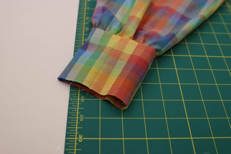 How To Flip Cuffs Right Sides Out - Rainbow Checks Cotton Shirting - Mood Fabrics - Bayport Blouse Free Sewing Pattern Tutorial - MDF494 - Mood Fabrics Sewciety Blog - Flip the cuffs right sides out.