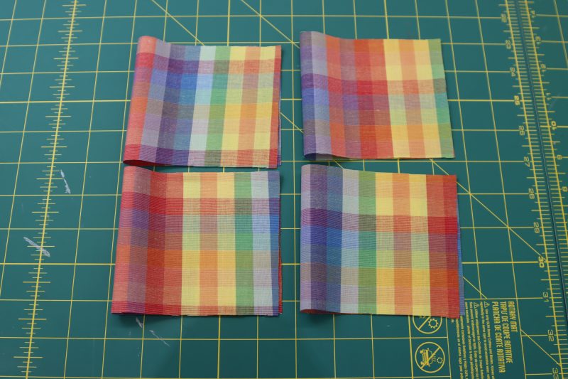 How To Fold Sleeve Cuffs - Rainbow Checks Cotton Shirting - Mood Fabrics - Bayport Blouse Free Sewing Pattern Tutorial - MDF494 - Mood Fabrics Sewciety Blog - Fold the sleeve cuffs right sides together.