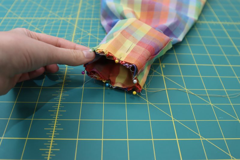 How To Pin Cuffs To Sleeves - Rainbow Checks Cotton Shirting - Mood Fabrics - Bayport Blouse Free Sewing Pattern Tutorial - MDF494 - Mood Fabrics Sewciety Blog - Pin the sandwich of sleeve and cuffs.