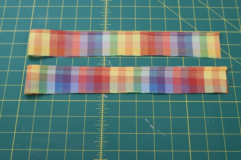 How To Fold Sleeve Ruffles Right Sides Together - Rainbow Checks Cotton Shirting - Mood Fabrics - Bayport Blouse Free Sewing Pattern Tutorial - MDF494 - Mood Fabrics Sewciety Blog - Fold the sleeve ruffles right sides together.