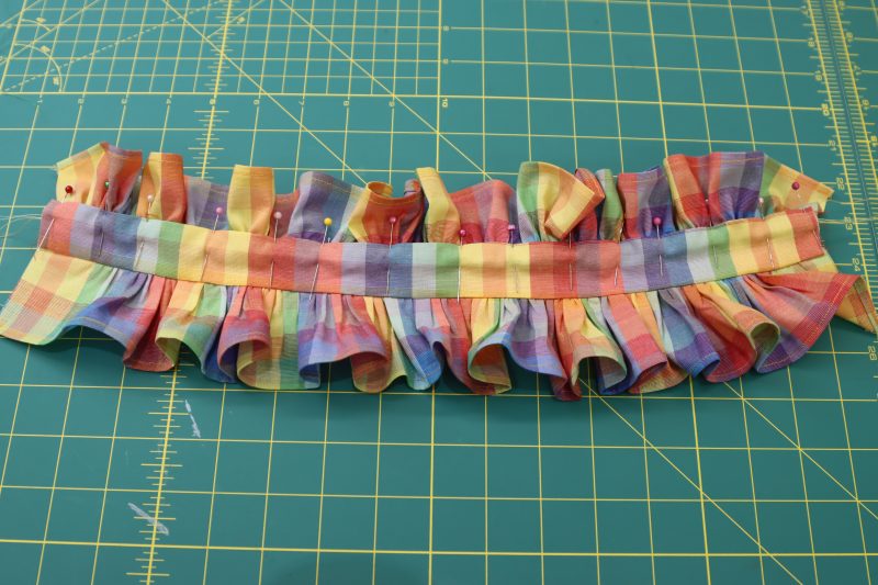 How To Sandwich Top Ruffle Between Collar Pieces - Rainbow Checks Cotton Shirting - Mood Fabrics - Bayport Blouse Free Sewing Pattern Tutorial - MDF494 - Mood Fabrics Sewciety Blog - Sandwich the top ruffle in between the collar pieces.