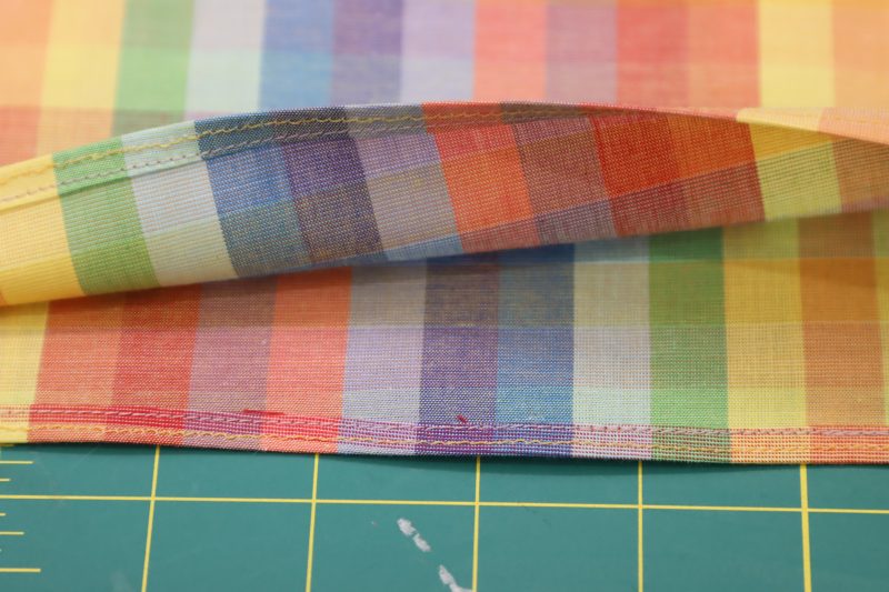 How To Hem Blouse Raw Edges - Rainbow Checks Cotton Shirting - Mood Fabrics - Bayport Blouse Free Sewing Pattern Tutorial - MDF494 - Mood Fabrics Sewciety Blog - Hem the bottom of the blouse.