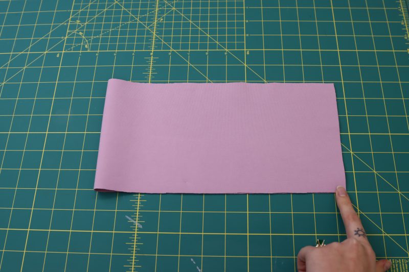 How To Fold Wasitband Right Sides Together - Stretch Ponte Knit - Mood Fabrics - Camarillo Cardigan and Magdalene Midi Skirt Free Sewing Pattern Tutorial - MDF490 - Mood Fabrics Sewciety Blog - Fold the waistband in half right sides together with the two shorter ends of the rectangle laying one on top of the other.