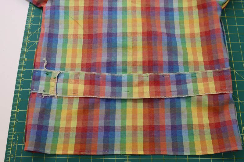 How To Pin Elastic Casing To Blouse Waistline - Rainbow Checks Cotton Shirting - Mood Fabrics - Bayport Blouse Free Sewing Pattern Tutorial - MDF494 - Mood Fabrics Sewciety Blog - Pin the elastic casing to the waistline of the blouse.