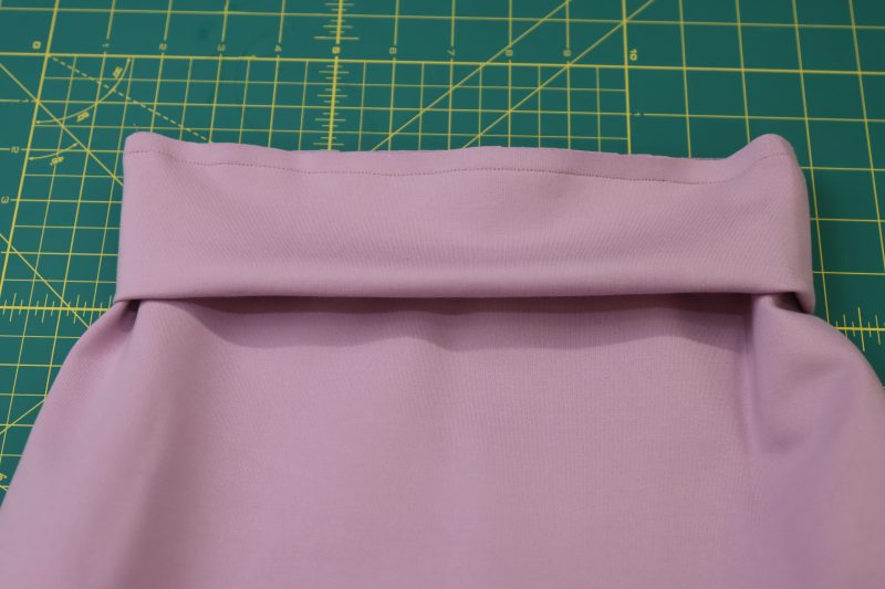 How To Pin Sew Waistband To Wasitline - Stretch Ponte Knit - Mood Fabrics - Camarillo Cardigan and Magdalene Midi Skirt Free Sewing Pattern Tutorial - MDF490 - Mood Fabrics Sewciety Blog - Sew the waistband to the waistline of the skirt.