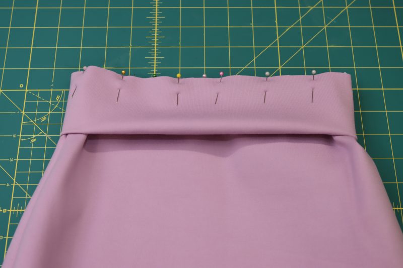 How To Pin Waistband To Wasitline - Stretch Ponte Knit - Mood Fabrics - Camarillo Cardigan and Magdalene Midi Skirt Free Sewing Pattern Tutorial - MDF490 - Mood Fabrics Sewciety Blog - Pin the waistband around the waistline of the skirt.