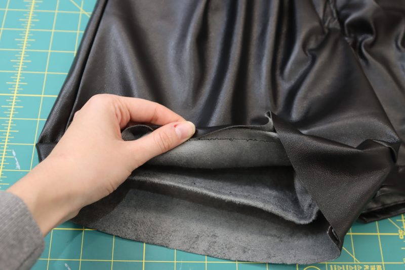 How To Wrap Shorts Hem Raw Edge - Buttery Faux Leather - Mood Fabrics - Dresden Shorts Free Sewing Pattern Tutorial - MDF493 - Mood Fabrics Sewciety Blog - Wrap the raw edge hem around the fold at the bottom of the shorts.