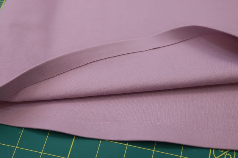 How To Iron Hem Tape - Stretch Ponte Knit - Mood Fabrics - Camarillo Cardigan and Magdalene Midi Skirt Free Sewing Pattern Tutorial - MDF490 - Mood Fabrics Sewciety Blog - Iron hem tape into the fold.