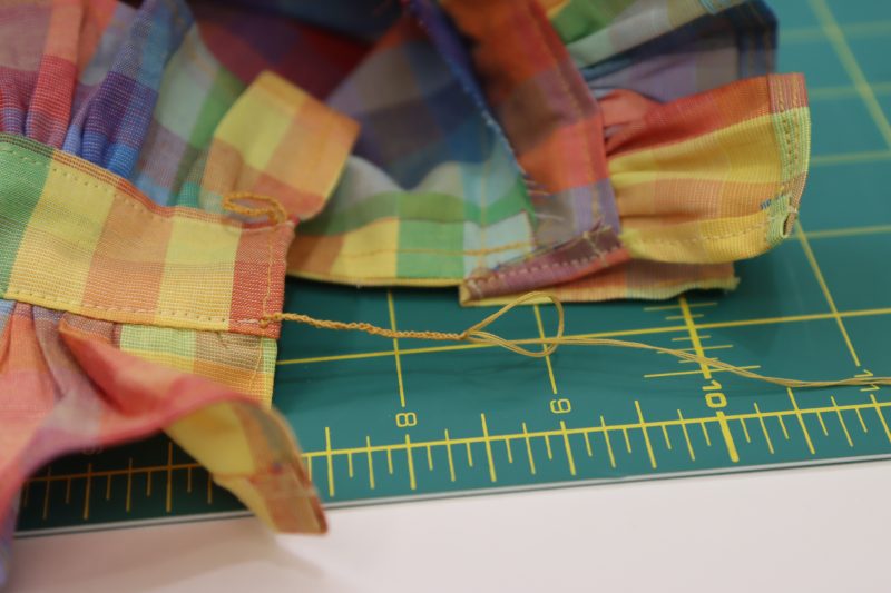 How To Pull Loose Thread Through Slip Knot - Gutermann Sew All Thread - Mood Fabrics - Bayport Blouse Free Sewing Pattern Tutorial - MDF494 - Mood Fabrics Sewciety Blog - Pull the loose thread through the final loop.