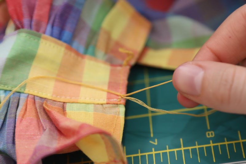How To Pull Original Slip Knot Tight - Gutermann Sew All Thread - Mood Fabrics - Bayport Blouse Free Sewing Pattern Tutorial - MDF494 - Mood Fabrics Sewciety Blog - Tighten the original slip knot.