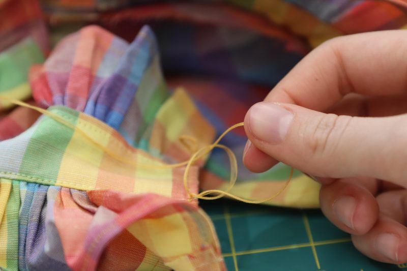 How To Pull Thread Through Slip Know - Gutermann Sew All Thread - Mood Fabrics - Bayport Blouse Free Sewing Pattern Tutorial - MDF494 - Mood Fabrics Sewciety Blog - Pull the loose thread into a new loop.