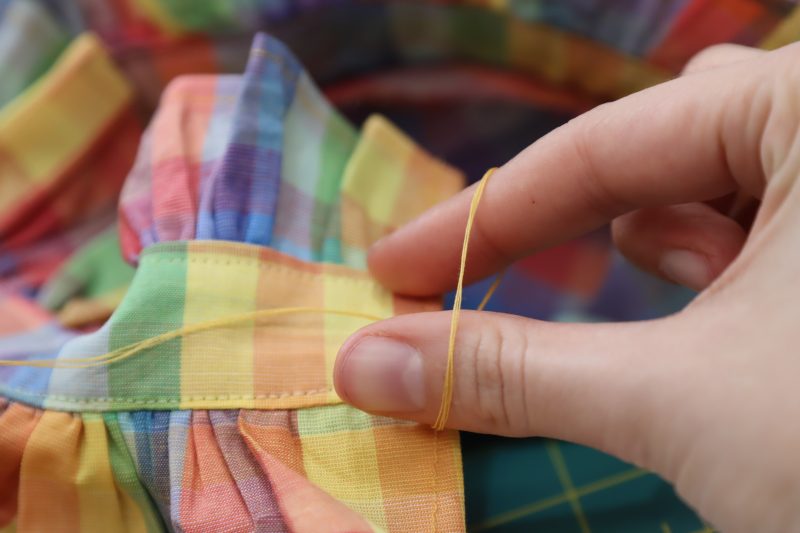 How To Reach Through Slip Knot - Gutermann Sew All Thread - Mood Fabrics - Bayport Blouse Free Sewing Pattern Tutorial - MDF494 - Mood Fabrics Sewciety Blog - Reach through the slip knot to grab the loose thread.