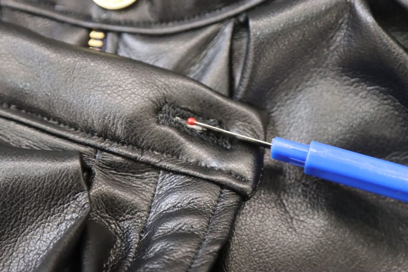 How To Open Button Hole With Seam Ripper - Buttery Faux Leather - Mood Fabrics - Dresden Shorts Free Sewing Pattern Tutorial - MDF493 - Mood Fabrics Sewciety Blog - Open the buttonhole with a seam ripper.