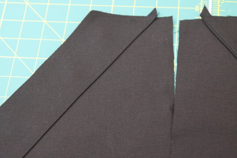 How To Pin Sew Pocket Facings On Front Pockets - Cotton Canvas - Mood Fabrics - Clarkston Carpenter Pants Free Sewing Pattern Tutorial - MDF503 - Mood Fabrics Sewciety Blog - Pin and sew the pocket facings to the front pockets.