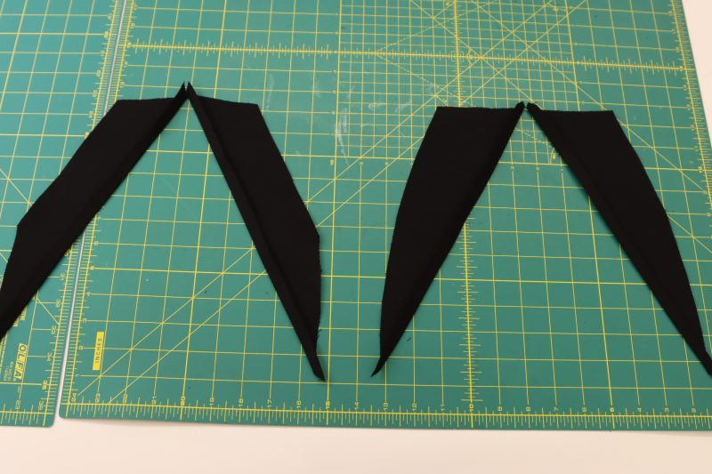 How To Press Pocket Facings - Cotton Canvas - Mood Fabrics - Clarkston Carpenter Pants Free Sewing Pattern Tutorial - MDF503 - Mood Fabrics Sewciety Blog - Fold and press the diagonal edges of the pocket facings.