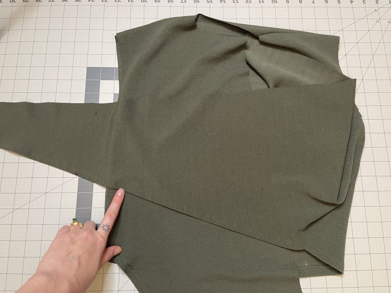 How To Hem Shirt Hem - Stretch Liverpool Knit - Mood Fabrics - Cove Collared Wrap Top Free Sewing Pattern Tutorial - MDF498 - Mood Fabrics Sewciety Blog - Hem the bottom of the twist top.