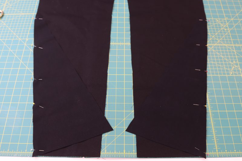How To Pin Sew Side Bottom Pieces To Back Pant - Cotton Canvas - Mood Fabrics - Clarkston Carpenter Pants Free Sewing Pattern Tutorial - MDF503 - Mood Fabrics Sewciety Blog - Pin and sew the side bottom pieces to the back pants pieces.