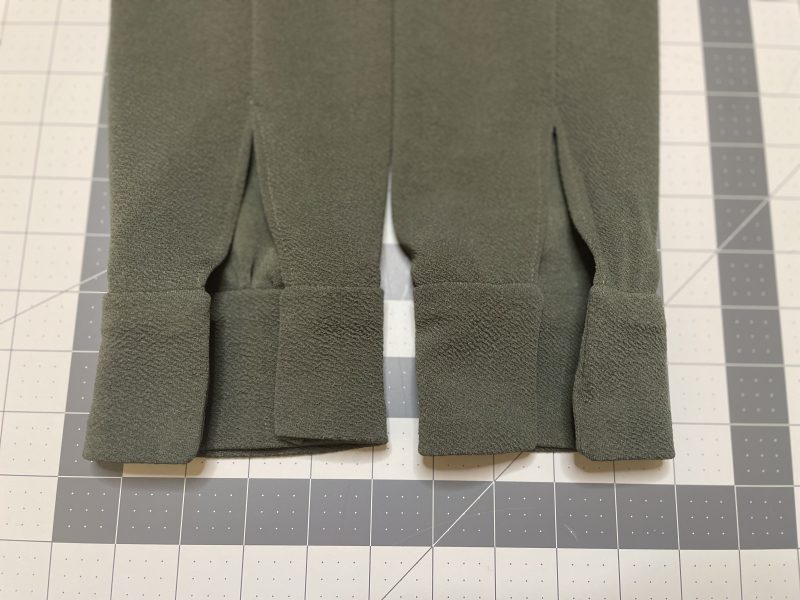 How To Fold Cuff Raw Edges In - Stretch Liverpool Knit - Mood Fabrics - Cove Collared Wrap Top Free Sewing Pattern Tutorial - MDF498 - Mood Fabrics Sewciety Blog - Fold the raw edges of the cuffs into the wrong side of the top and press into place.