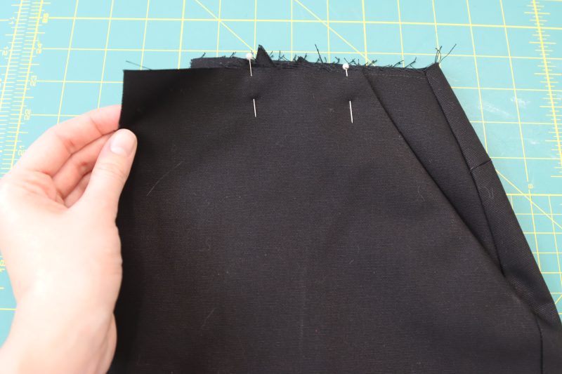 How To Pin Front Pocket To Waistline - Cotton Canvas - Mood Fabrics - Clarkston Carpenter Pants Free Sewing Pattern Tutorial - MDF503 - Mood Fabrics Sewciety Blog - Pin the top of the pocket to the waistline of the pants.