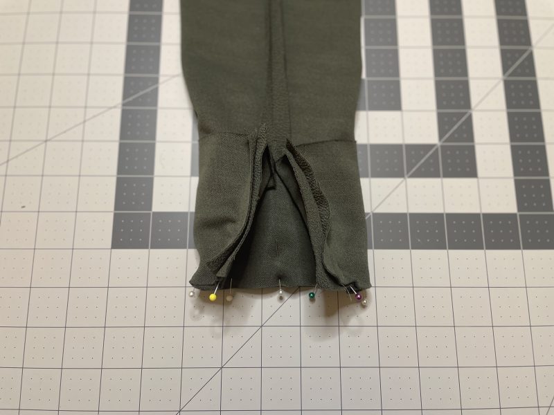 How To Sandwich Sleeves In Between Cuffs - Stretch Liverpool Knit - Mood Fabrics - Cove Collared Wrap Top Free Sewing Pattern Tutorial - MDF498 - Mood Fabrics Sewciety Blog - Sandwich the end of the sleeve into the cuff, right sides together.