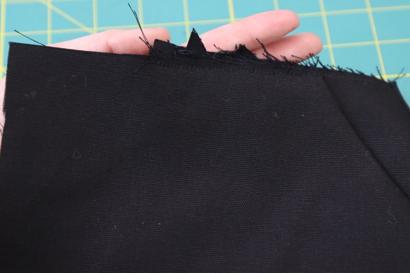 How To Sew Front Pocket To Waistline - Cotton Canvas - Mood Fabrics - Clarkston Carpenter Pants Free Sewing Pattern Tutorial - MDF503 - Mood Fabrics Sewciety Blog - Sew the pocket to the waistline with ¼ inch seam allowance.