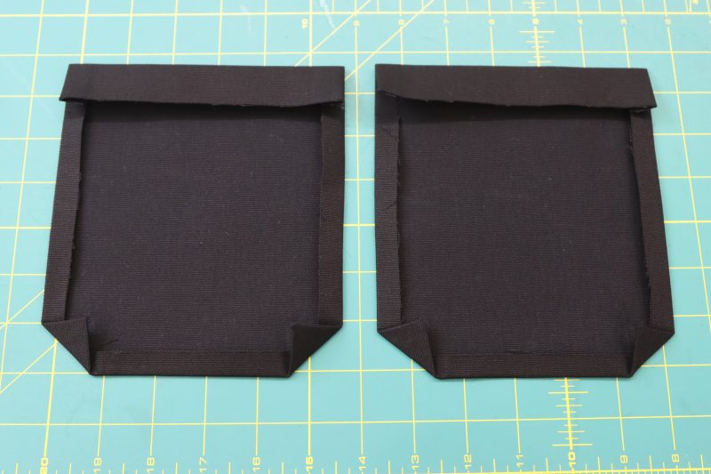How To Fold Back Pocket Edges - Cotton Canvas - Mood Fabrics - Clarkston Carpenter Pants Free Sewing Pattern Tutorial - MDF503 - Mood Fabrics Sewciety Blog - Fold the edges of the pockets towards the wrong side of the fabric.