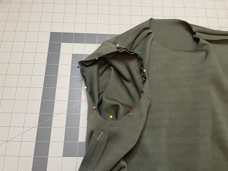 How To Pin Sleeve Caps To Armscyes - Stretch Liverpool Knit - Mood Fabrics - Cove Collared Wrap Top Free Sewing Pattern Tutorial - MDF498 - Mood Fabrics Sewciety Blog - Pin the sleeve caps to the armscyes.