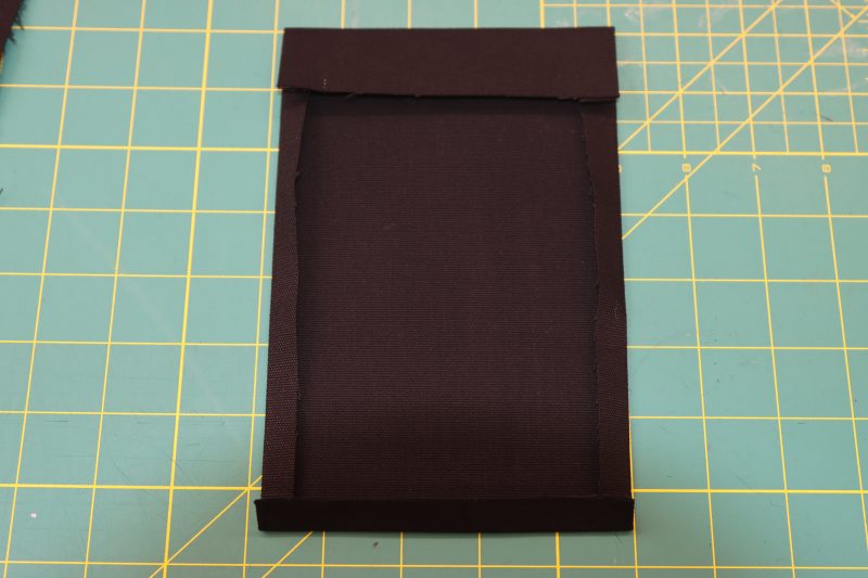 How To Fold Side Pocket Edges - Cotton Canvas - Mood Fabrics - Clarkston Carpenter Pants Free Sewing Pattern Tutorial - MDF503 - Mood Fabrics Sewciety Blog - Fold the edges of the pockets towards the wrong side of the fabric.