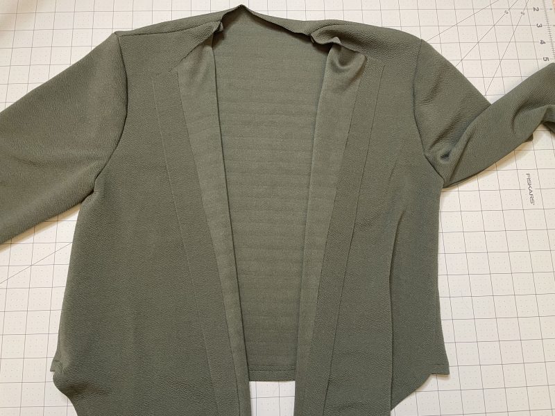 How To Iron Hem Tape Into Button Placket - Stretch Liverpool Knit - Mood Fabrics - Cove Collared Wrap Top Free Sewing Pattern Tutorial - MDF498 - Mood Fabrics Sewciety Blog - Iron hem tape into the button placket.