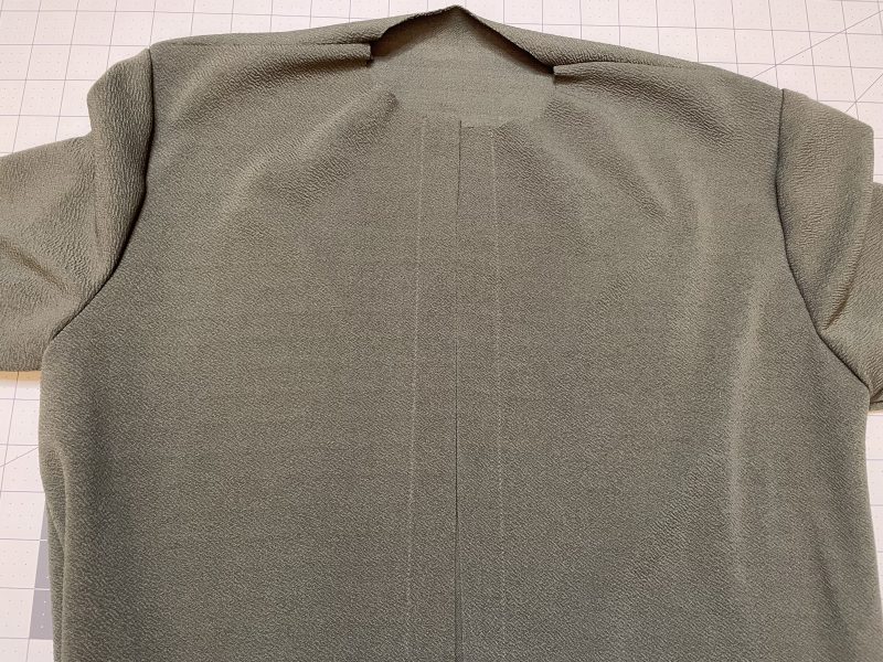 How To Topstitch Over Button Placket - Gutermann Sew All Thread - Mood Fabrics - Cove Collared Wrap Top Free Sewing Pattern Tutorial - MDF498 - Mood Fabrics Sewciety Blog - Topstitch over the button placket with 1 inch seam allowance.