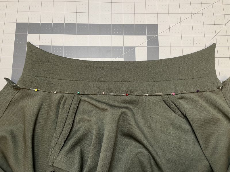 How To Pin Collar Stand Raw Edges - Stretch Liverpool Knit - Mood Fabrics - Cove Collared Wrap Top Free Sewing Pattern Tutorial - MDF498 - Mood Fabrics Sewciety Blog - Pin the raw edge of the collar to the neckline.