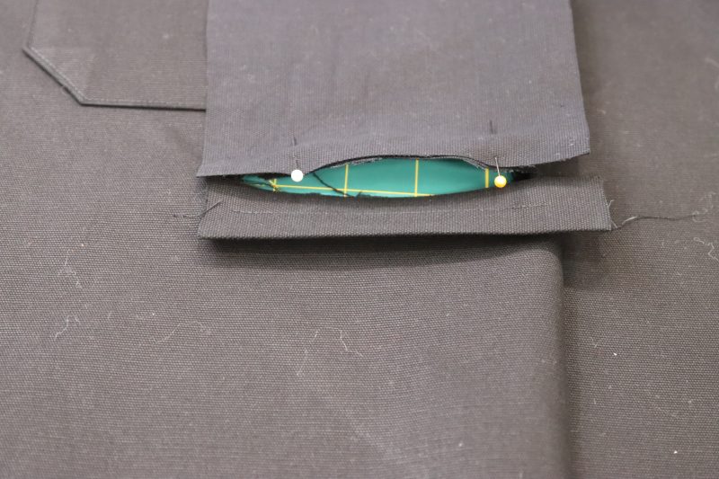 How To Pin Welt Pocket Lining - Cotton Canvas - Mood Fabrics - Clarkston Carpenter Pants Free Sewing Pattern Tutorial - MDF503 - Mood Fabrics Sewciety Blog - Pin the welt pocket lining to the top chalk mark.