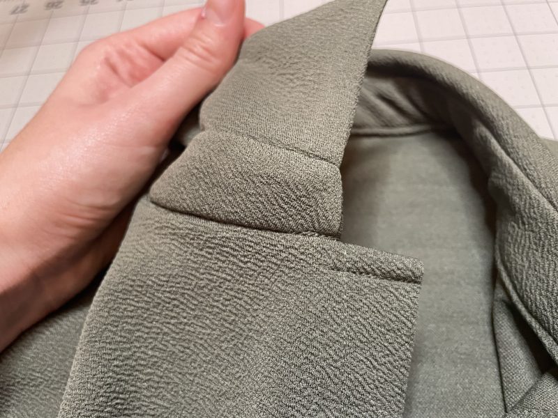 How To Sew Stitch In The Ditch For Collar Stand - Stretch Liverpool Knit - Mood Fabrics - Cove Collared Wrap Top Free Sewing Pattern Tutorial - MDF498 - Mood Fabrics Sewciety Blog - Sew stitch in the ditch around the collar stand and topstitch over the button placket.
