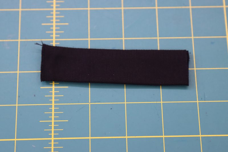 How To Flip Strap Right Sides Out - Cotton Canvas - Mood Fabrics - Clarkston Carpenter Pants Free Sewing Pattern Tutorial - MDF503 - Mood Fabrics Sewciety Blog - Flip the strap right sides out.
