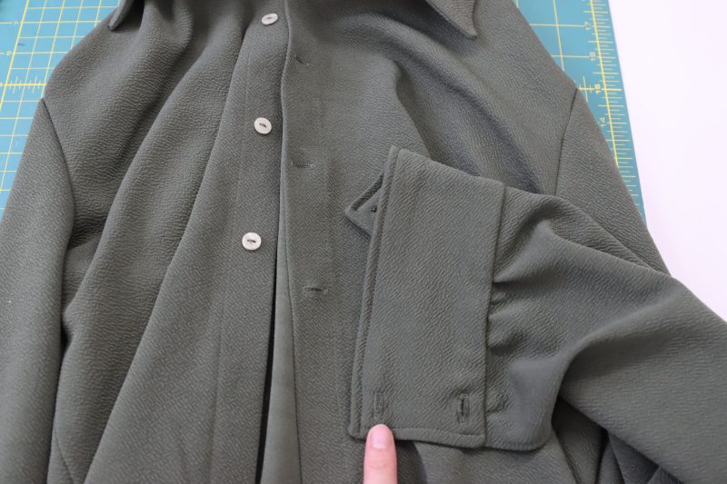 How To Insert Buttonholes Into Cuffs - Plastic 2 Hole Buttons - Mood Fabrics - Cove Collared Wrap Top Free Sewing Pattern Tutorial - MDF498 - Mood Fabrics Sewciety Blog - Insert buttonholes into the sleeve cuffs.
