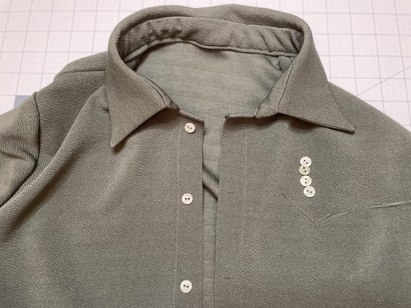 How To Sew Buttons On By Hand - Stretch Liverpool Knit - Mood Fabrics - Cove Collared Wrap Top Free Sewing Pattern Tutorial - MDF498 - Mood Fabrics Sewciety Blog - Hand sew buttons to the button placket.