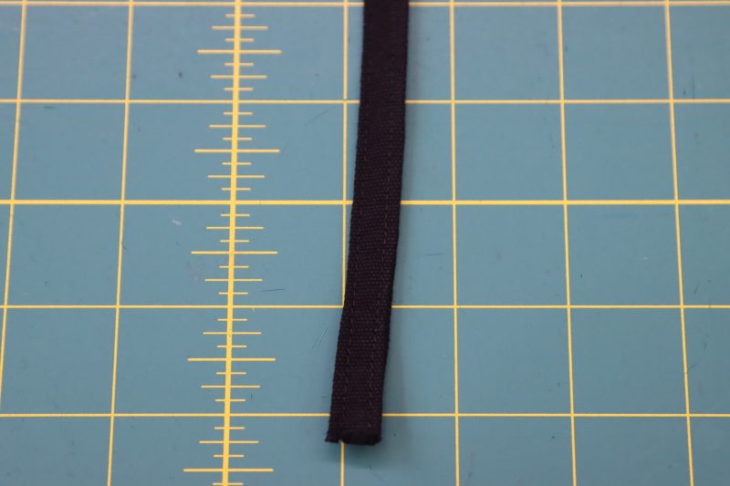 How To Flip Belt Loop Right Sides Out - Cotton Canvas - Mood Fabrics - Clarkston Carpenter Pants Free Sewing Pattern Tutorial - MDF503 - Mood Fabrics Sewciety Blog - Flip the belt loop strip right sides out with a loop turner.