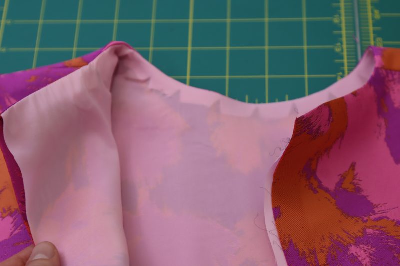 How To Flip Top Right Sides Out - Stretch Polyester Twill Lining - Mood Fabrics - Chelsea Brocade Set Free Sewing Pattern Tutorial - MDF508 - Mood Fabrics Sewciety Blog - Flip the top right sides out and press the neckline.