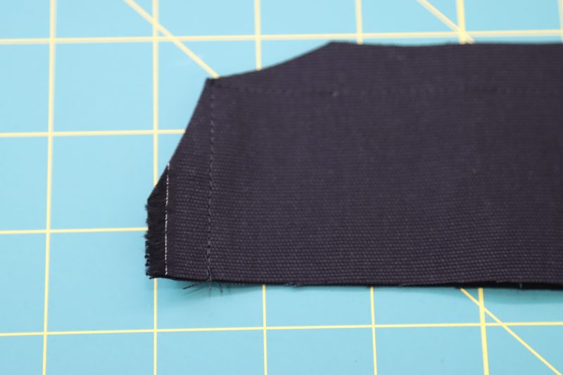 How To Clip Waistband Corners - Cotton Canvas - Mood Fabrics - Clarkston Carpenter Pants Free Sewing Pattern Tutorial - MDF503 - Mood Fabrics Sewciety Blog - Clip the corners on the waistband.